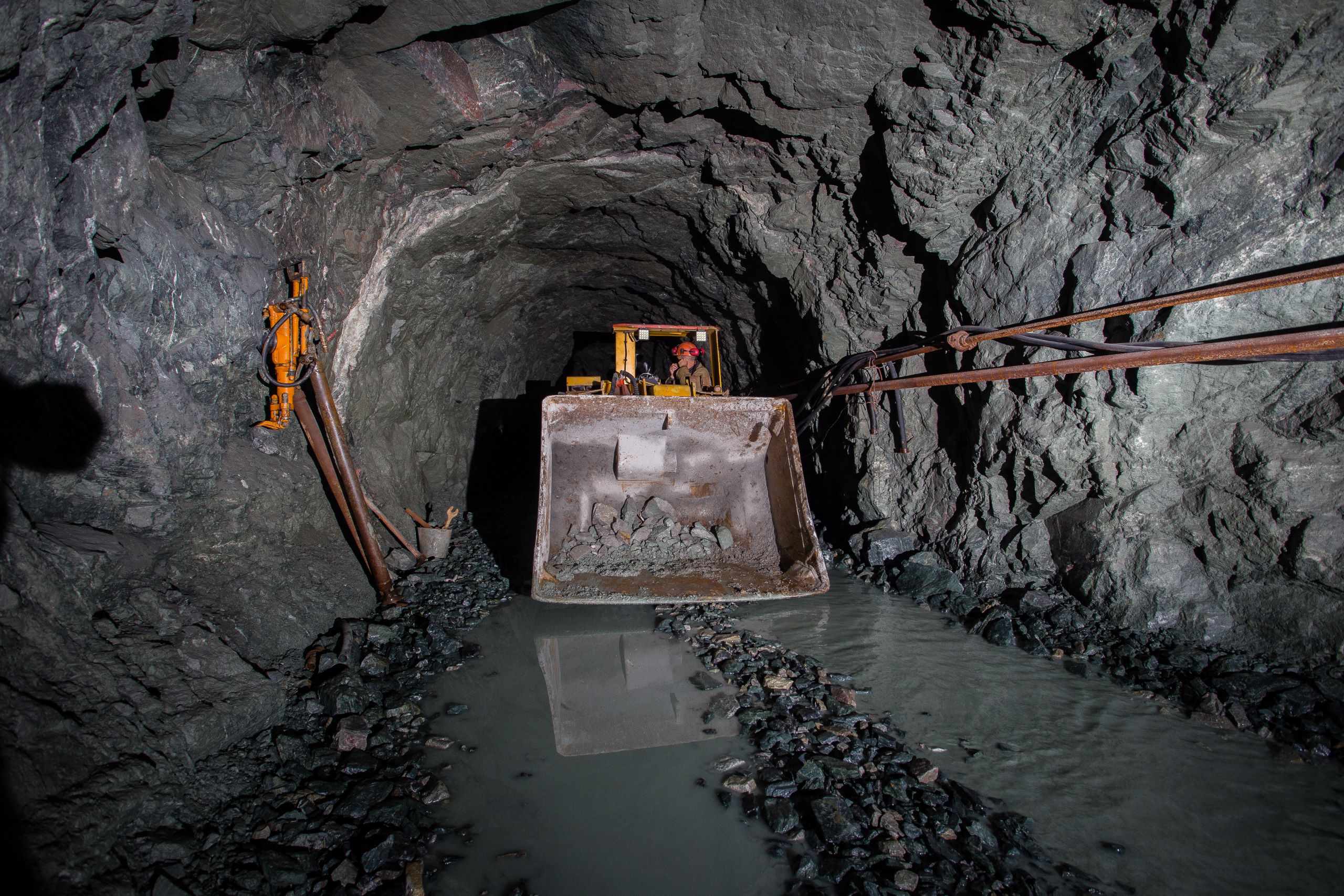 Scoop with bucket of rubble in shaft