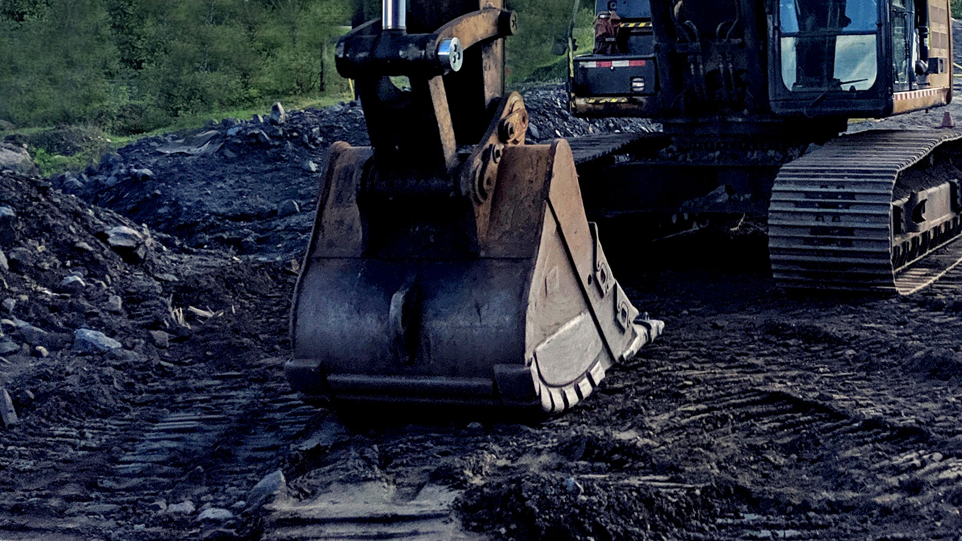 Hand Holding Brake Release Remote, underground scoop in the background